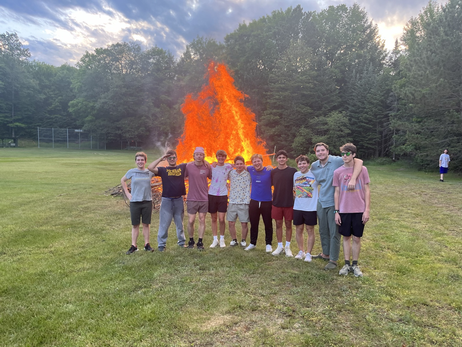 Leo and friends by a bonfire at dusk